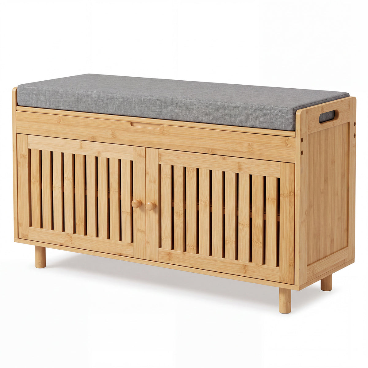 Natural bamboo bench with gray upholstered seat, slatted double doors, and short wooden legs on white.