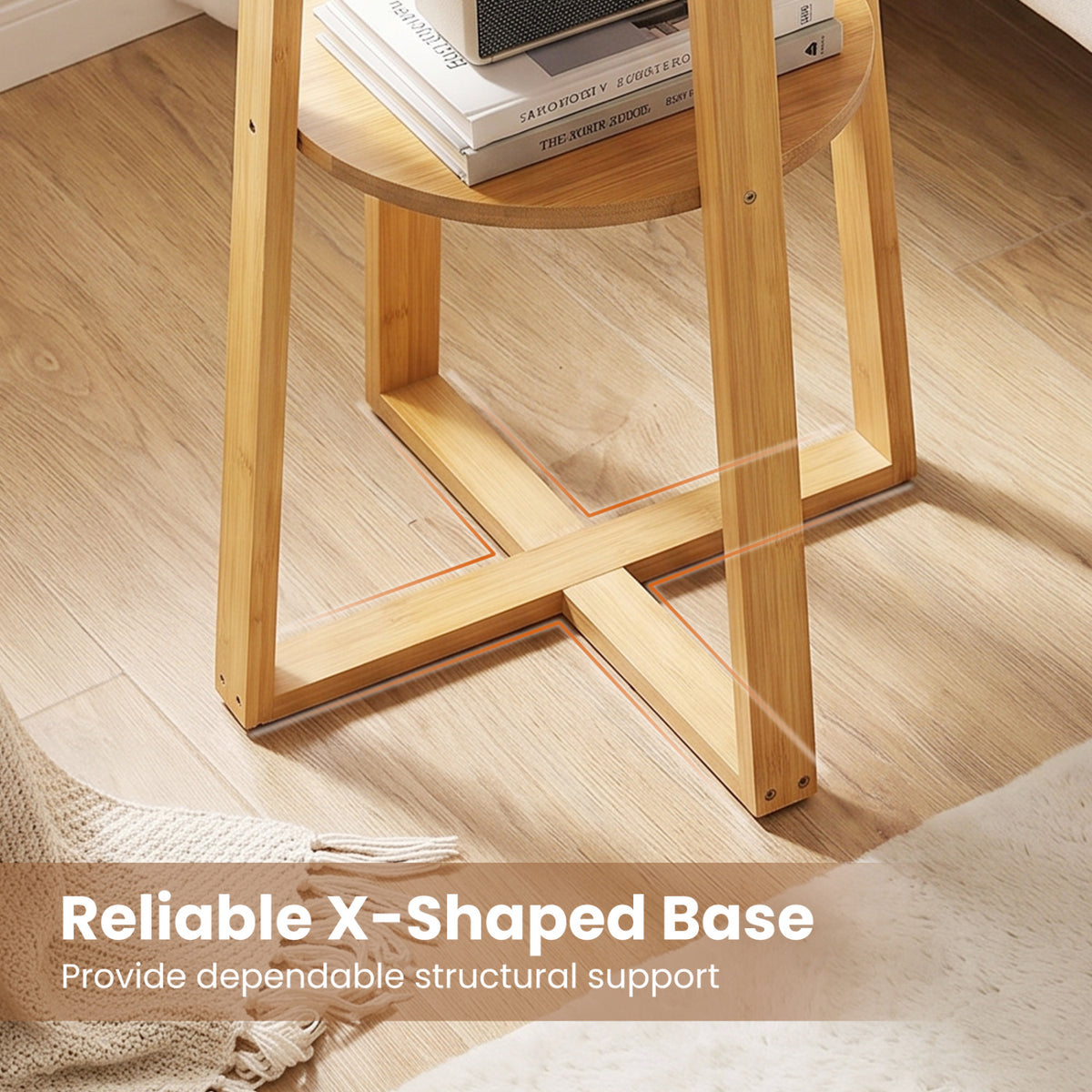 Close view of the table’s wooden X-shaped base, legs, and lower shelf above a wood floor.