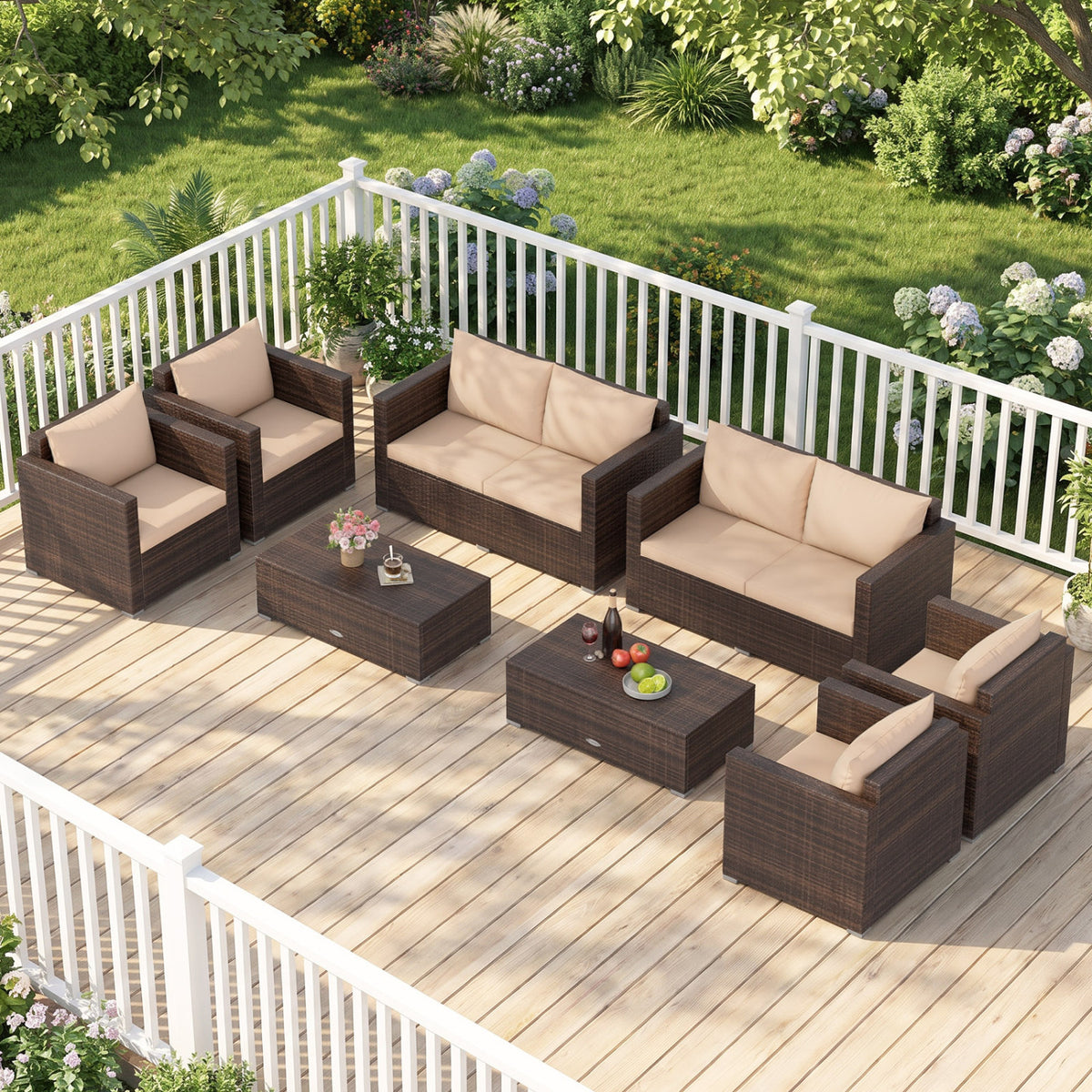 Dark woven rattan seating and two coffee tables arranged on a garden deck