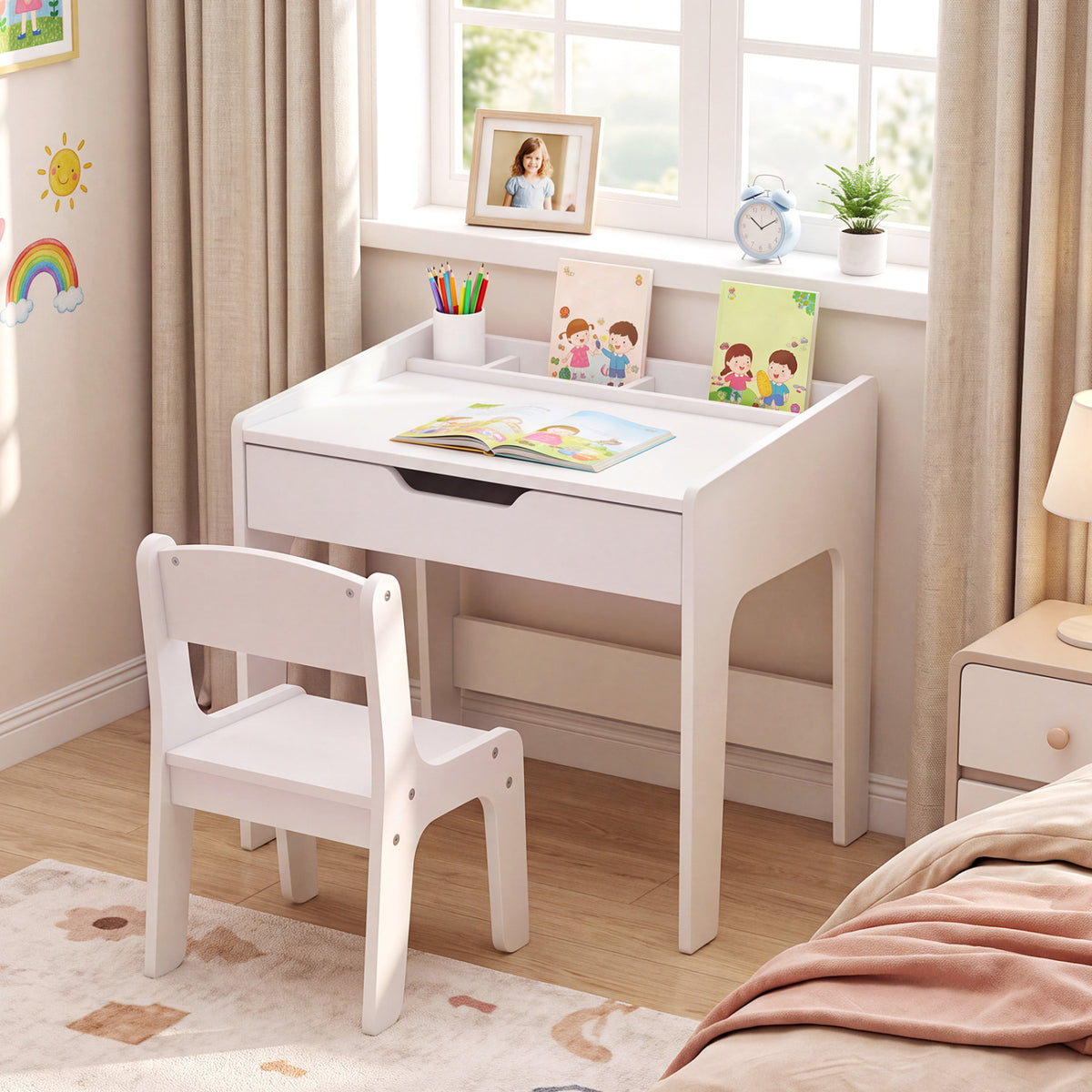 White child-sized desk and chair by a window, with books and art supplies on the desktop.