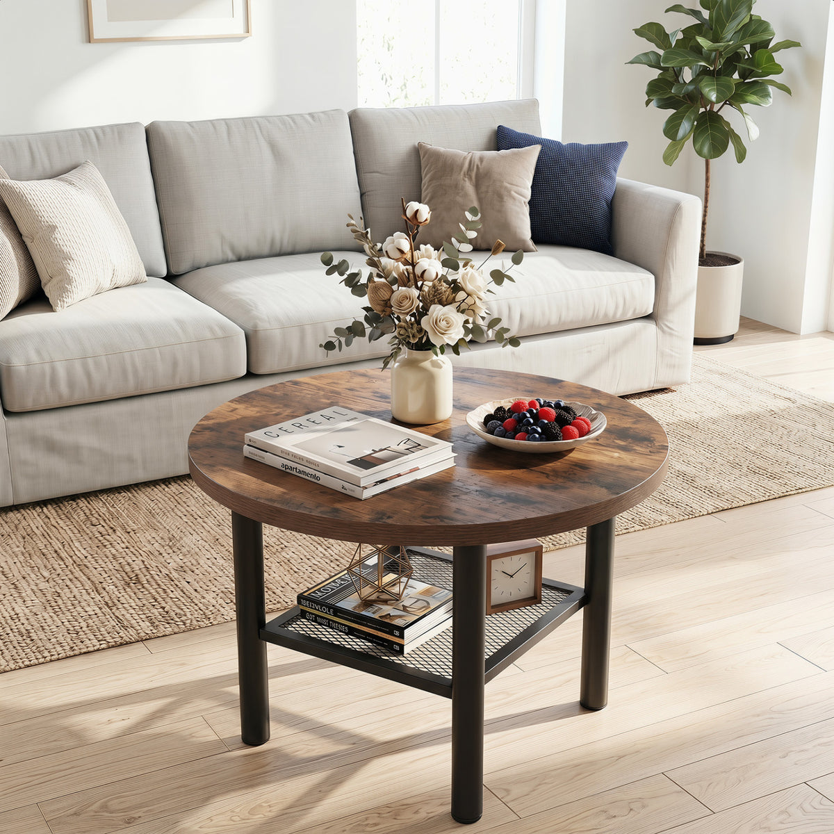 Round wood-look coffee table with a black metal frame and lower shelf in a bright living room.