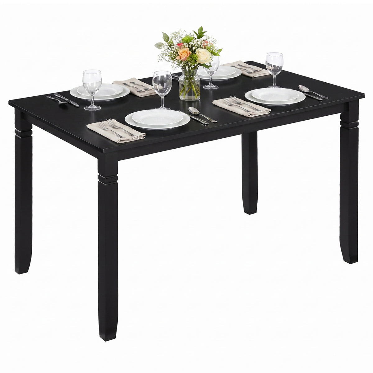 Black rectangular table set with four place settings and a small flower arrangement against a white background.