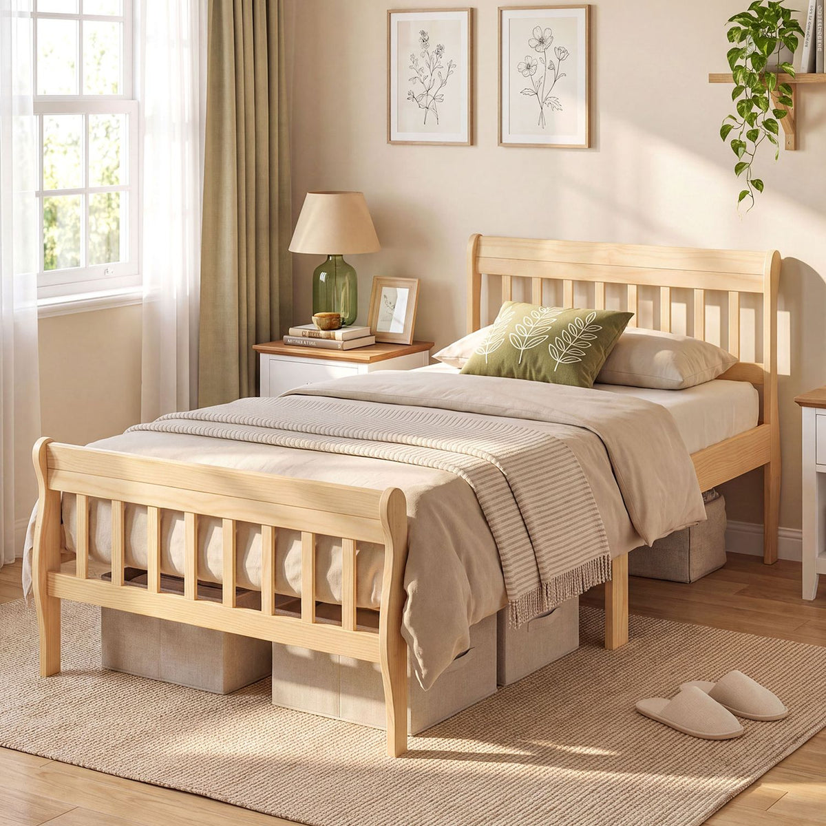 A light wood platform bed with a slatted headboard and footboard, dressed in neutral bedding beside a window.