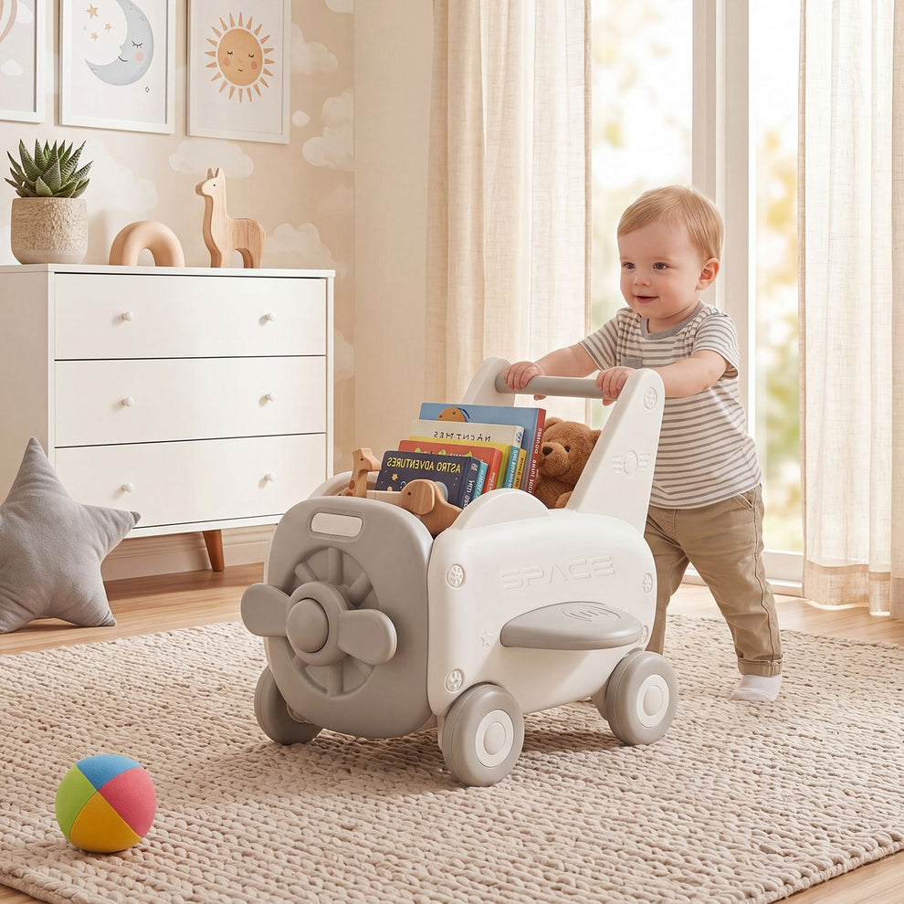 A toddler pushes a white airplane-shaped walker with toys in its storage compartment.