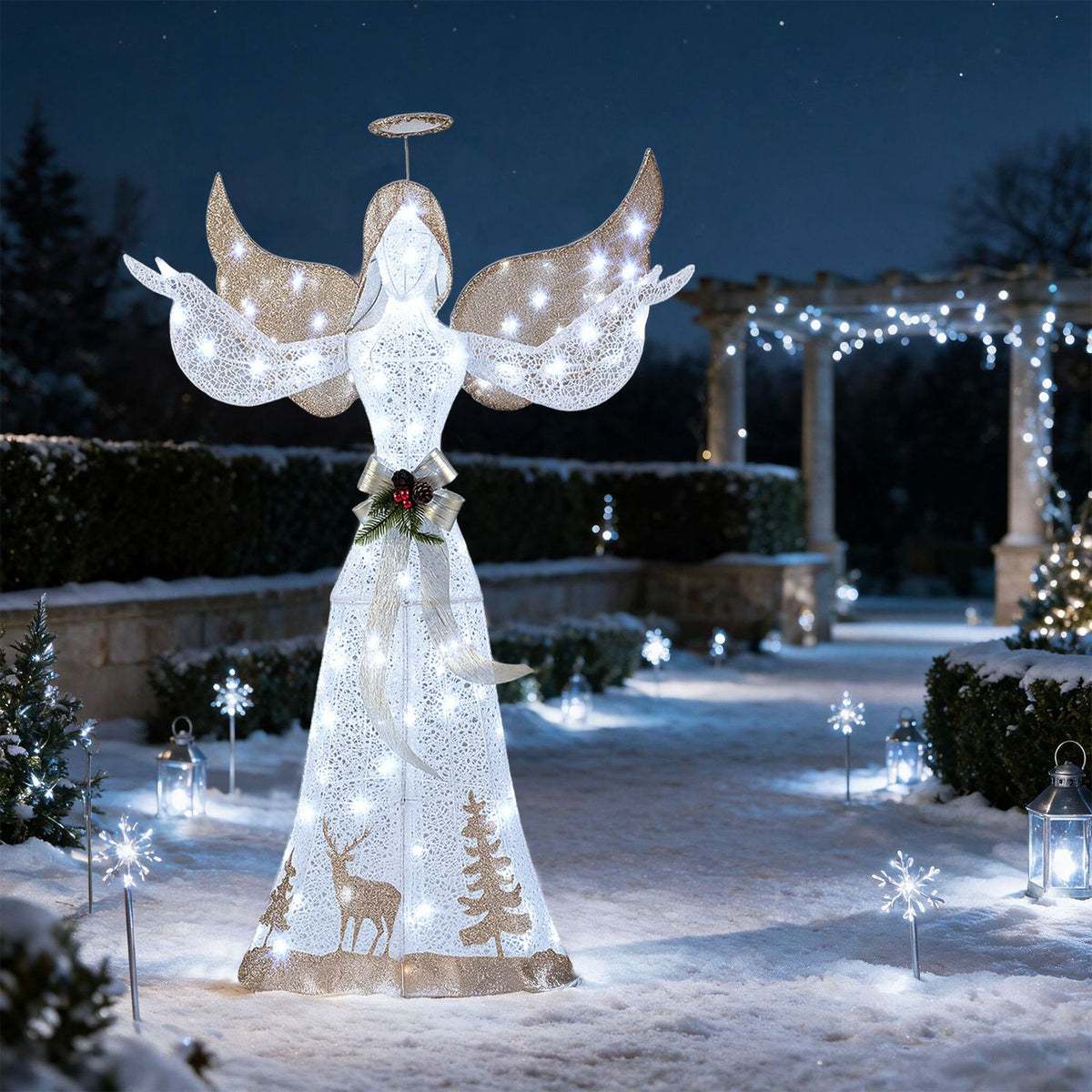 Illuminated angel stands in a snowy garden with glowing snowflake stakes and lanterns.