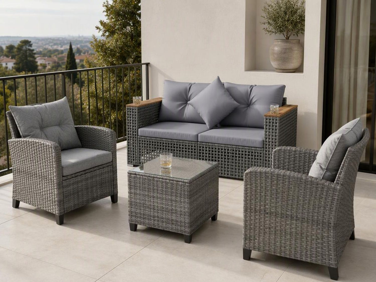 Gray woven patio sofa set with two armchairs and a glass-top coffee table on a tiled balcony.