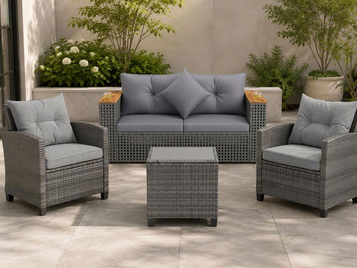 Gray woven outdoor sofa and two armchairs with cushions surround a matching coffee table on a patio.