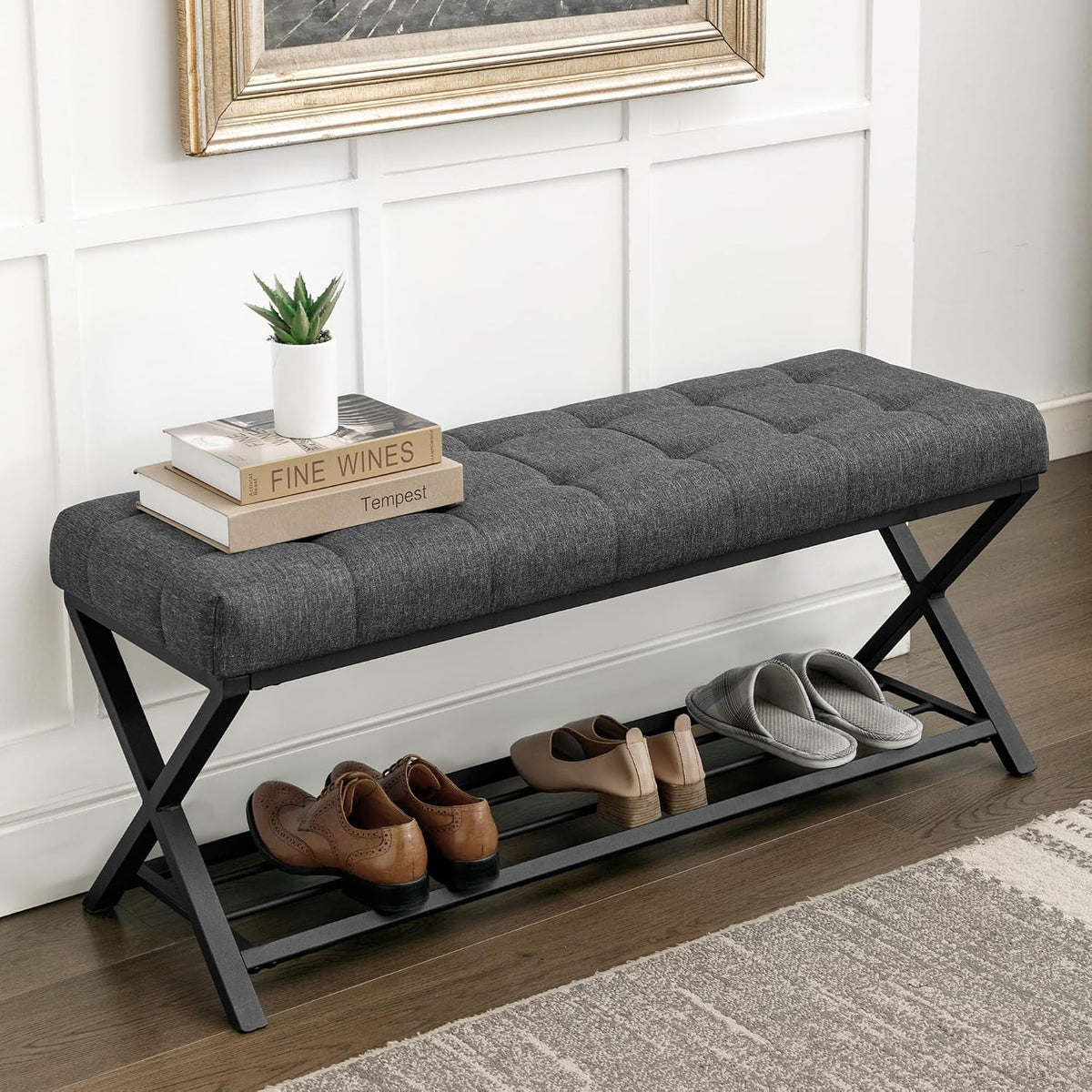 Dark gray fabric bench cushion with tufting and shoes stored on the lower rack, angled from right