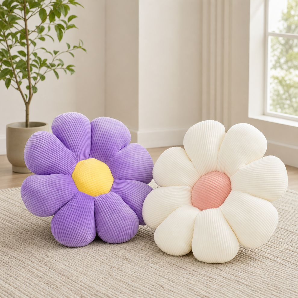 Purple daisy throw pillow with yellow center paired with cream daisy pillow with pink center on a neutral rug, front view