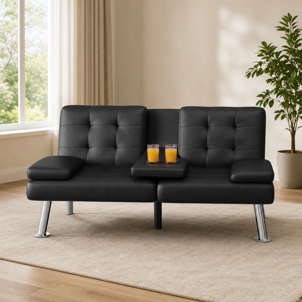 Black futon sofa with center cup-holder console, shown front-on in a bright living room.