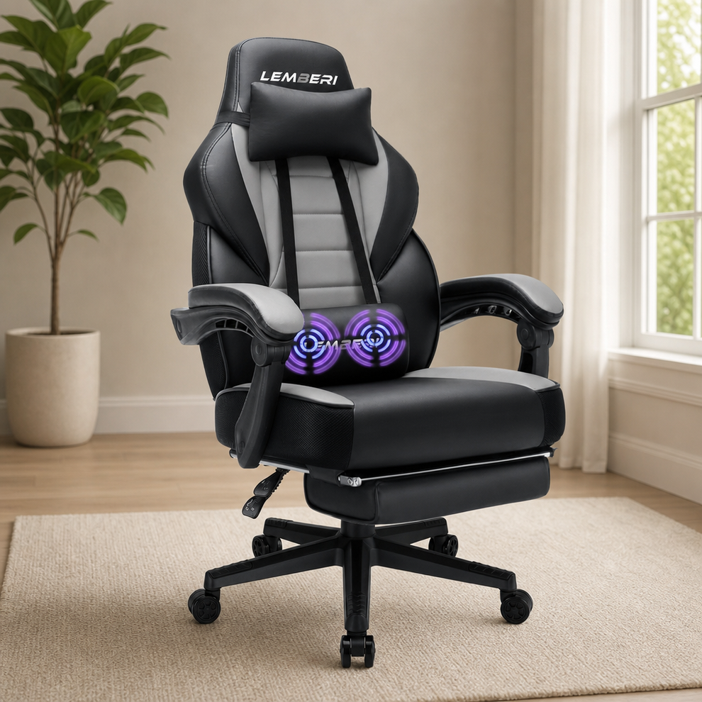 Black and gray gaming chair angled front view in a bright room with lumbar massage graphic and visible footrest