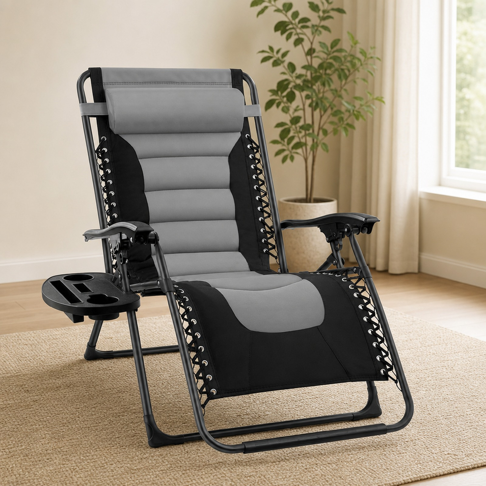 Black and gray padded zero-gravity recliner with side tray in a bright room