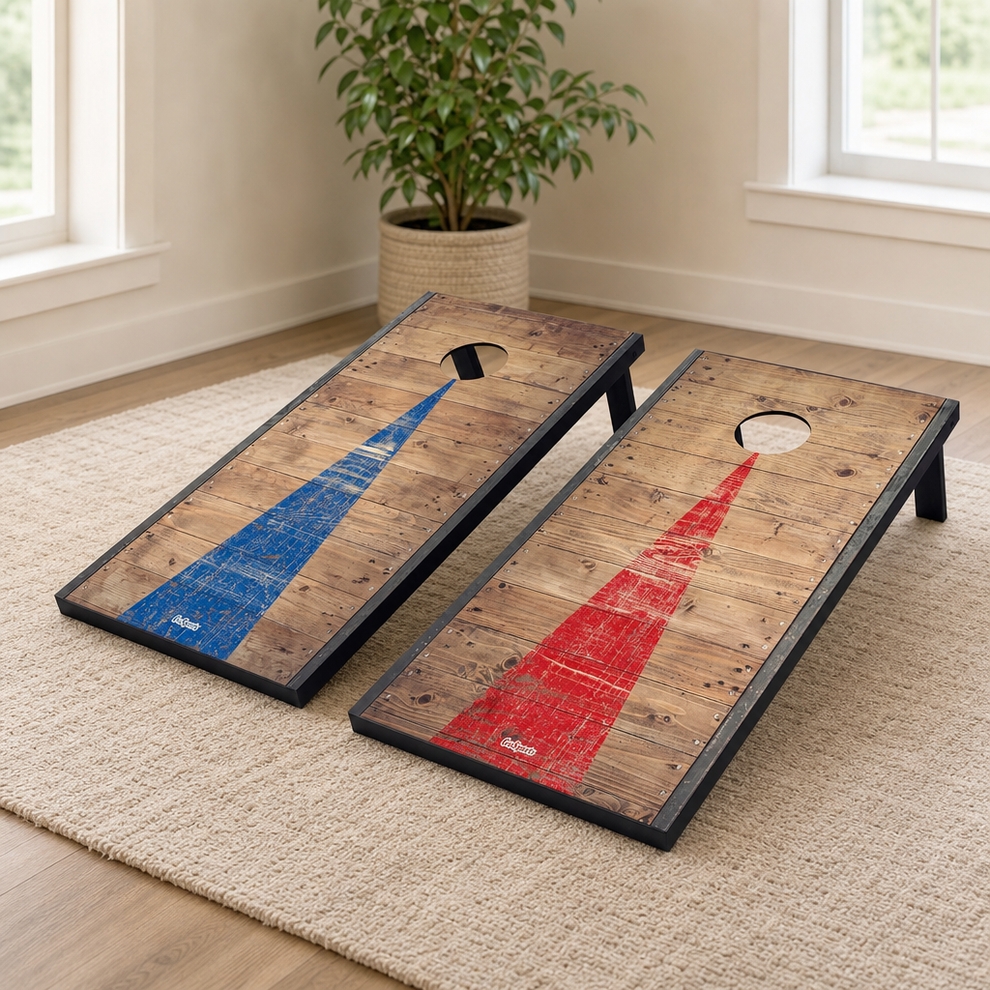 Pair of wood-design cornhole boards with blue and red center stripes angled on a light area rug