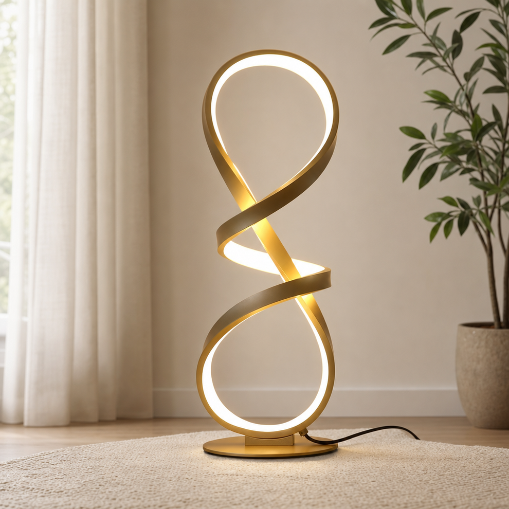 Gold spiral LED table lamp on a round base, angled front view in a bright room near a window.
