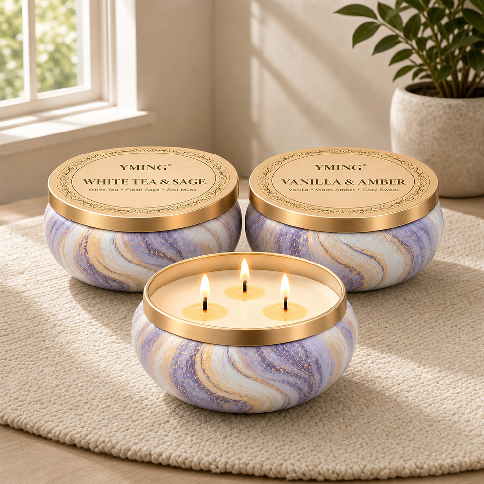 Three round lavender-and-gold marbled tin candles, one lid off showing three lit wicks on a textured rug