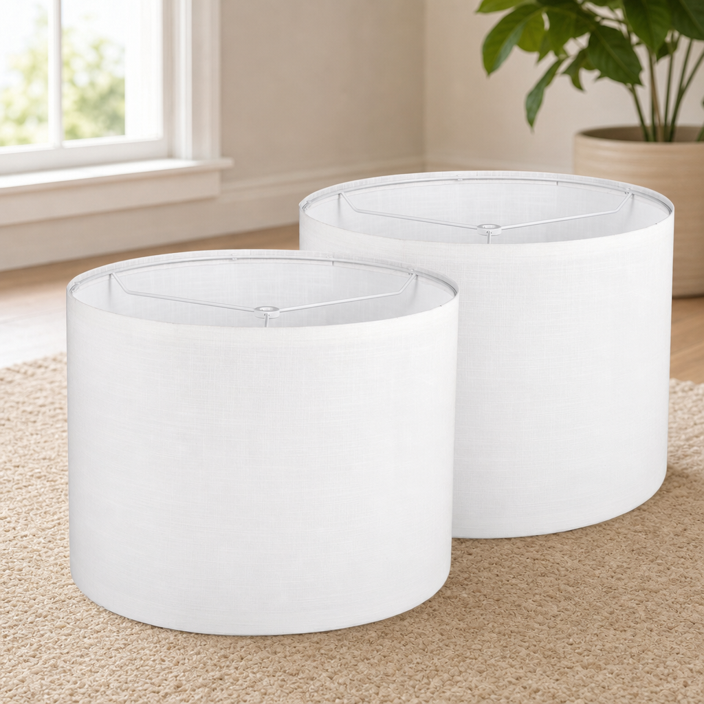 Two white drum lamp shades side-by-side on a carpeted floor with top metal frames visible