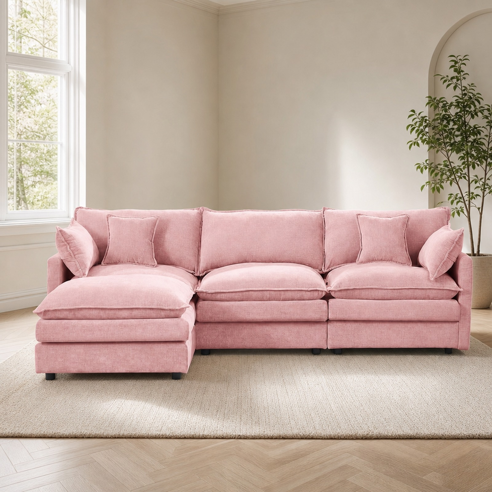 Pink chenille L-shaped sectional with ottoman, straight-on view in a bright living room