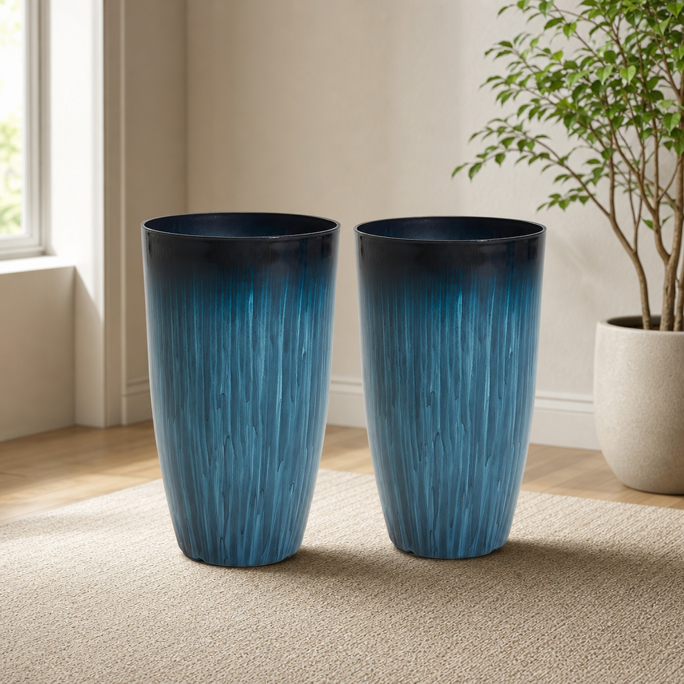 Two tall glossy blue gradient round floor planters side-by-side on a beige rug near a window