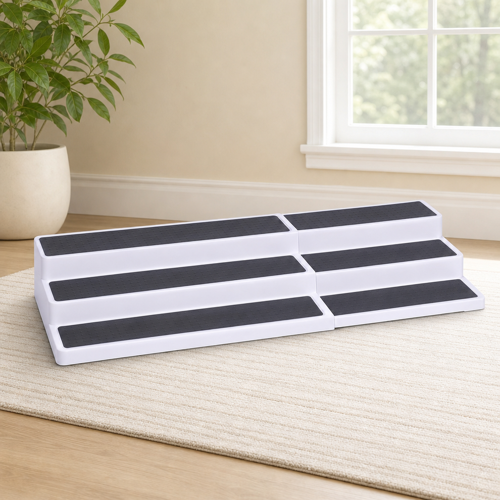 White three-tier expandable racks with dark textured shelf pads shown side-by-side on a rug