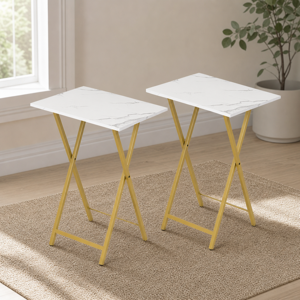 Marble-pattern tabletop with gold metal folding legs angled front view on a woven rug