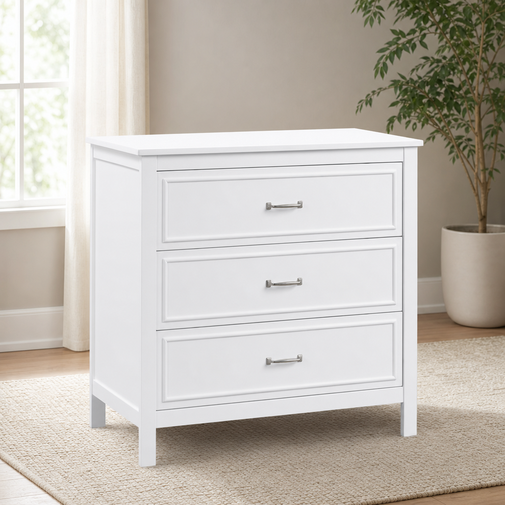 White 3-drawer dresser three-quarter front view on a beige rug in a nursery setting