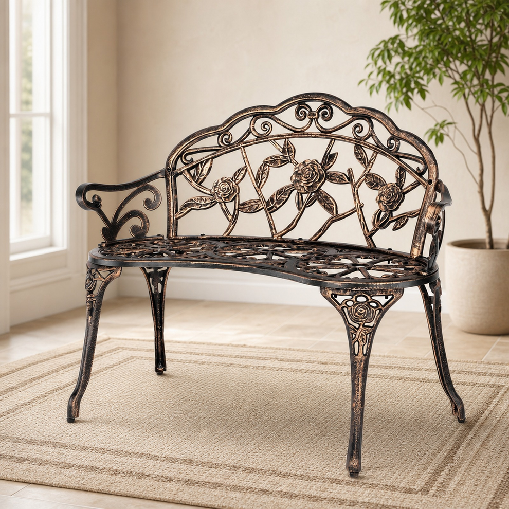 Bronze decorative garden bench angled in a bright room on a woven rug
