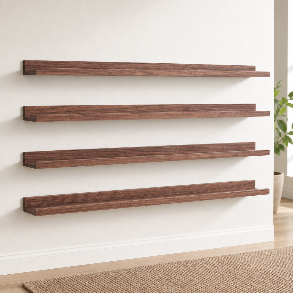 Walnut wood floating picture ledge set of four mounted on a white wall, angled front view