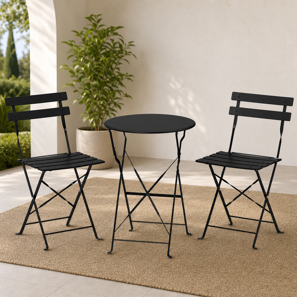 Black steel 3-piece bistro set on a patio rug with table and two chairs, angled front staging