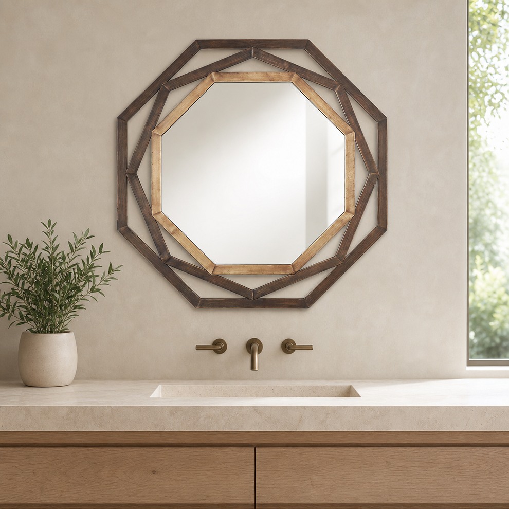 Two-tone bronze octagonal openwork wall mirror mounted above a bathroom sink and countertop, straight-on view