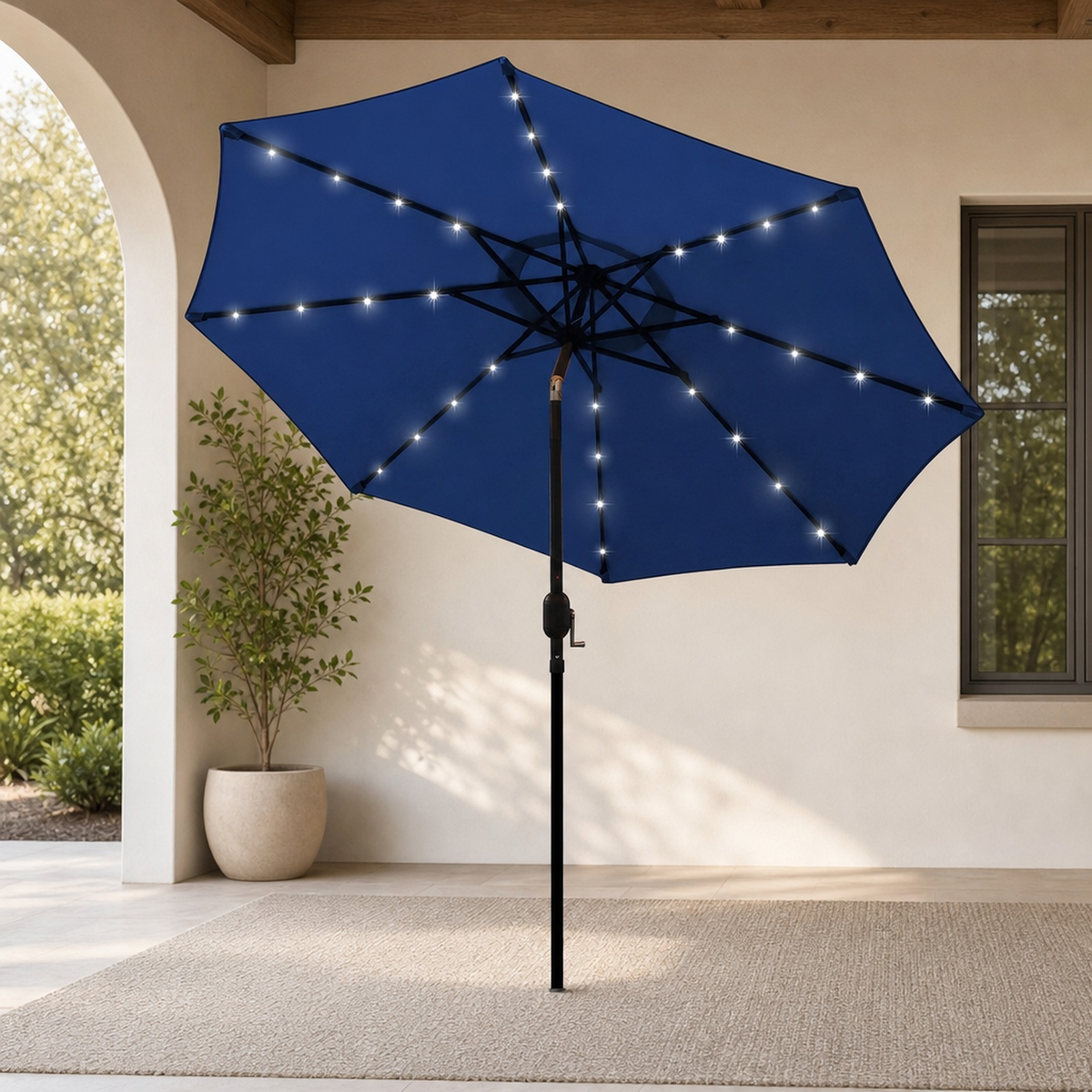 Navy blue LED patio umbrella open on a covered terrace, viewed from the front