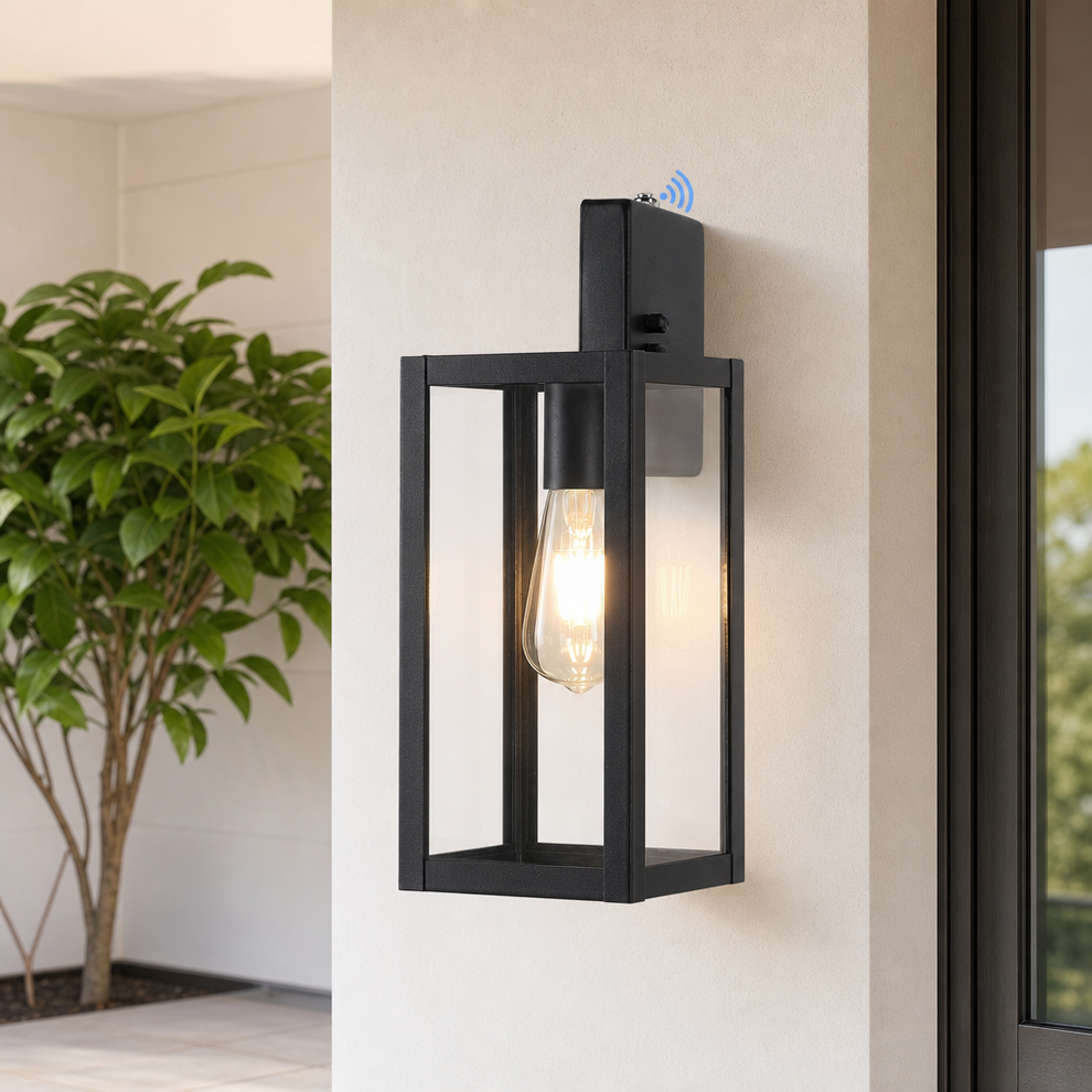 Dusk-to-Dawn Outdoor Wall Lanterns, Metal & Clear Glass, E26 Socket centered in a warm neutral furnished room