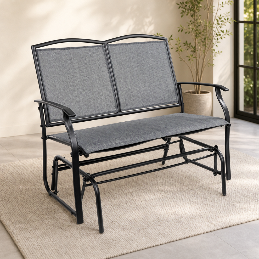 Gray mesh two-seat gliding bench angled front view in a bright room