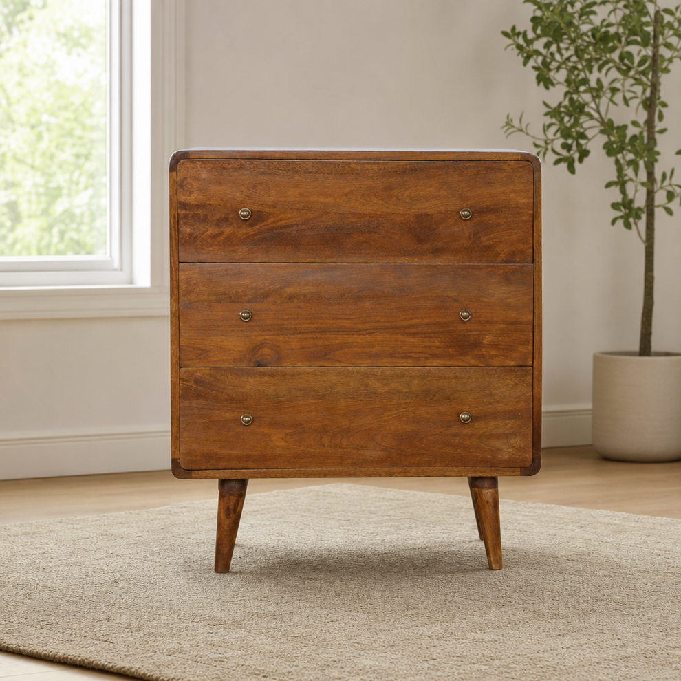 Curved Chest of Drawers in Chestnut Mango Wood centered in a warm neutral furnished room