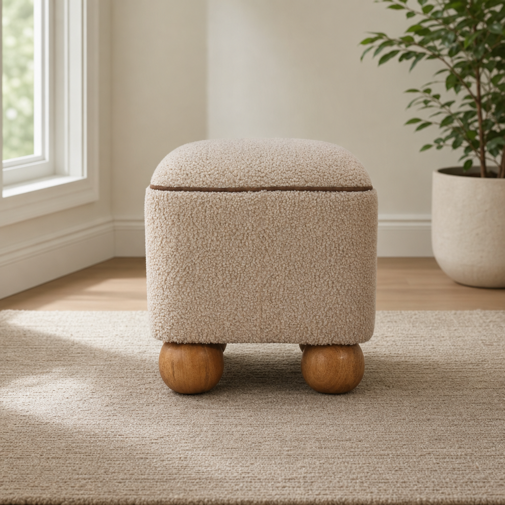 Round Upholstered Footstool with Ball Feet centered in a warm neutral furnished room