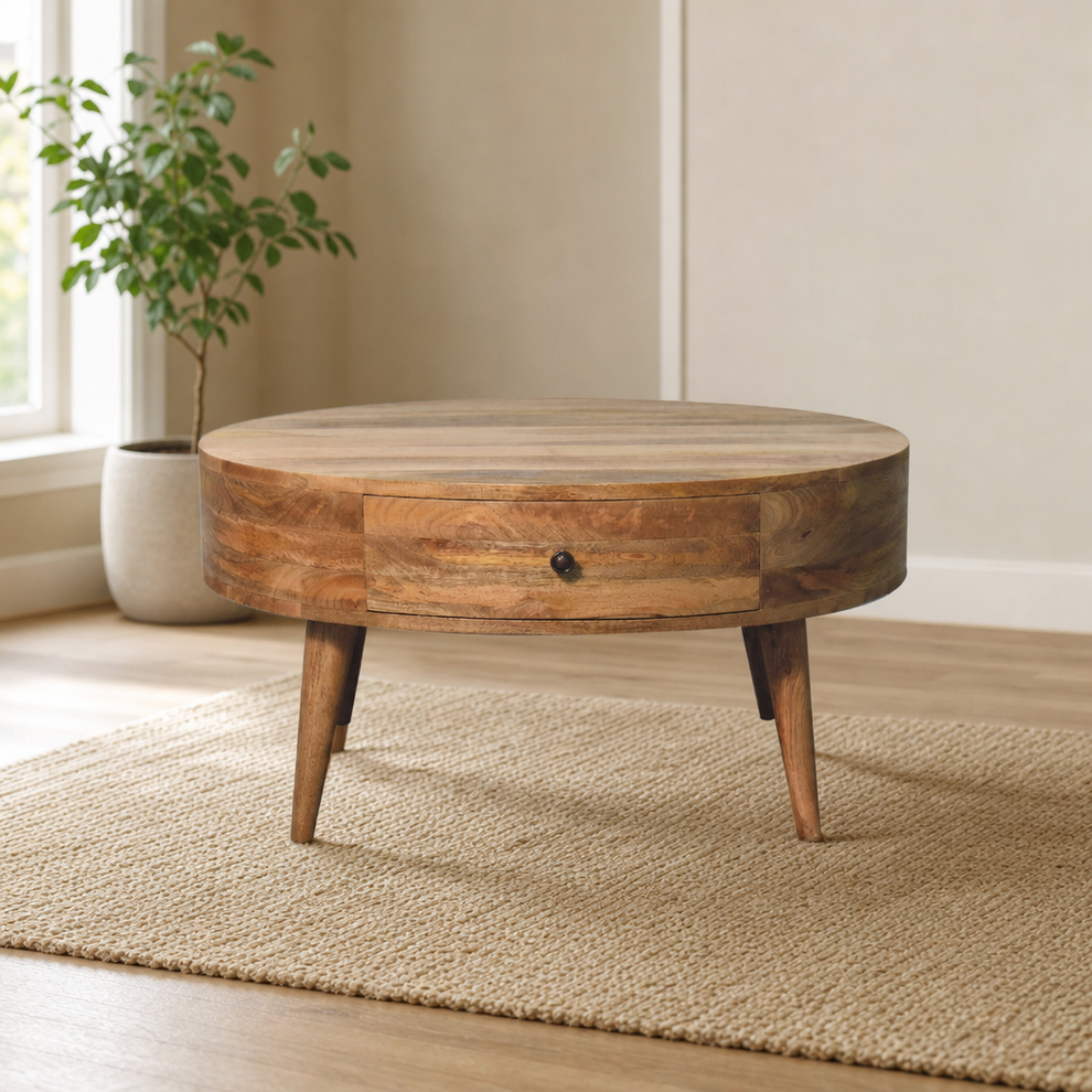 Coffee Table, Round Solid Mango Wood with Drawer, Oak-ish Finish centered in a warm neutral furnished room