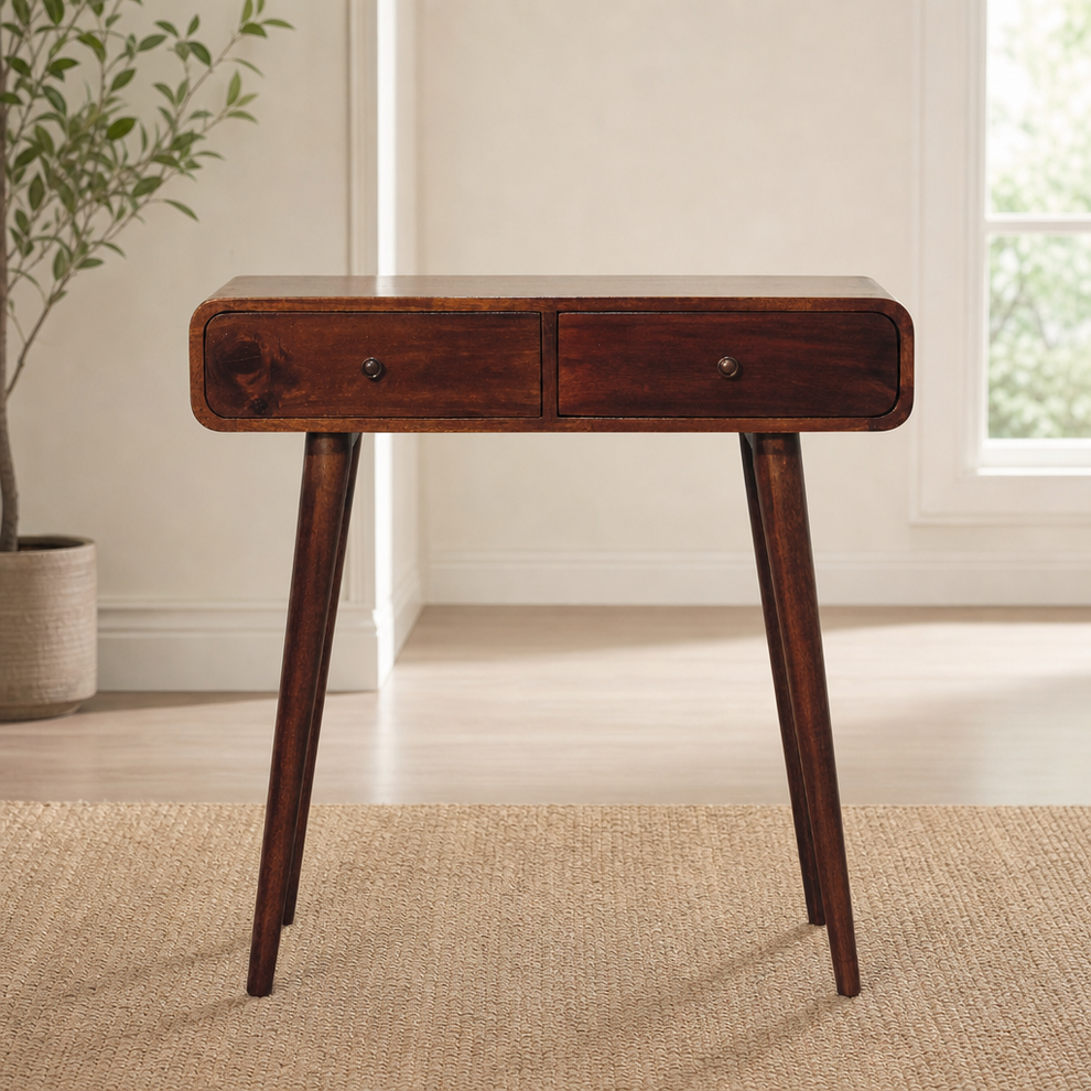 Curved Solid Mango Wood Console Table with Two Drawers centered in a warm neutral furnished room