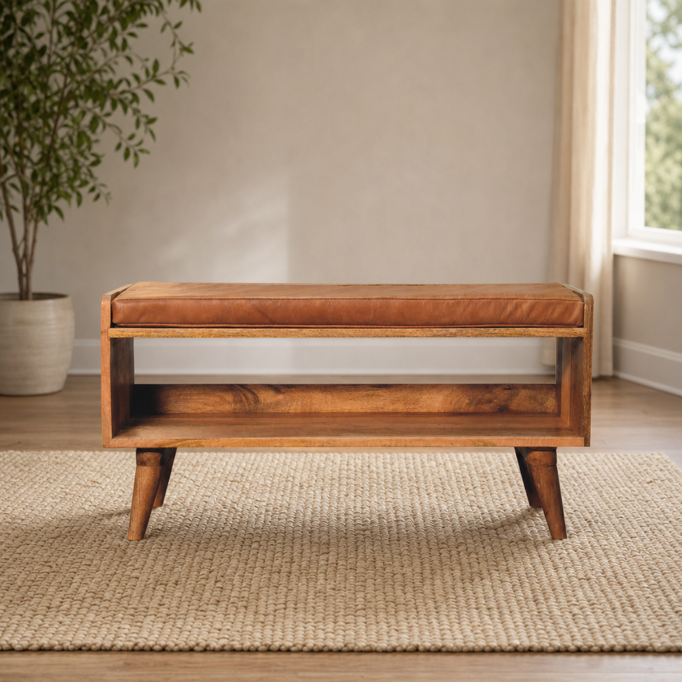 Solid Mango Wood Bench with Tan Leather Seat Pad centered in a warm neutral furnished room