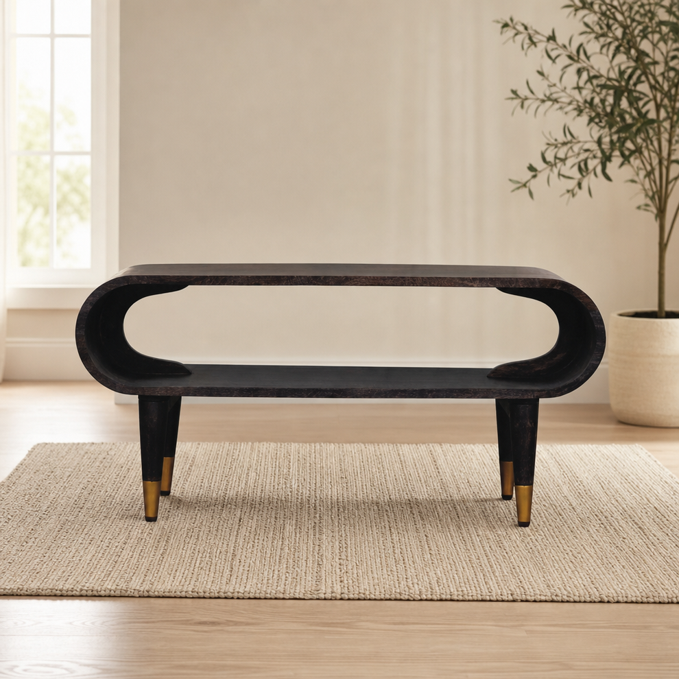 Curved Media Unit with Brass Accents centered in a warm neutral furnished room
