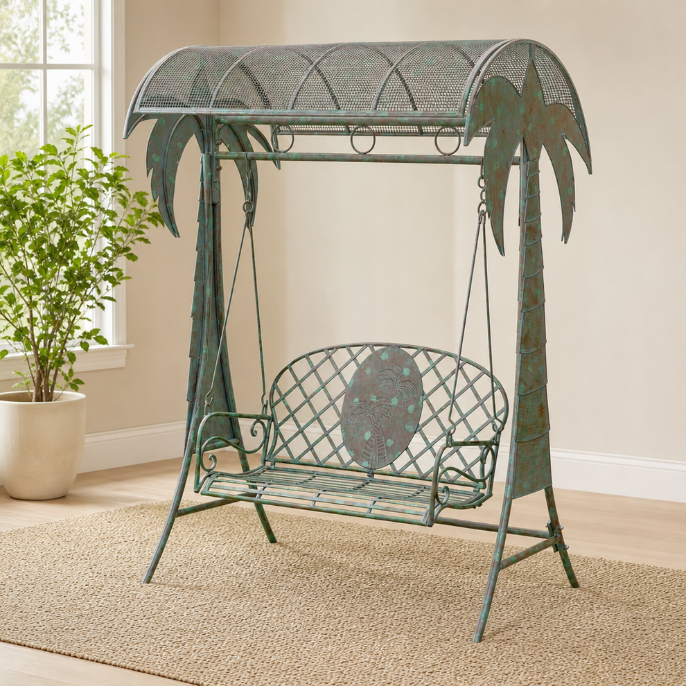 Verdi green iron swing bench with palm-tree supports, shown indoors from the front