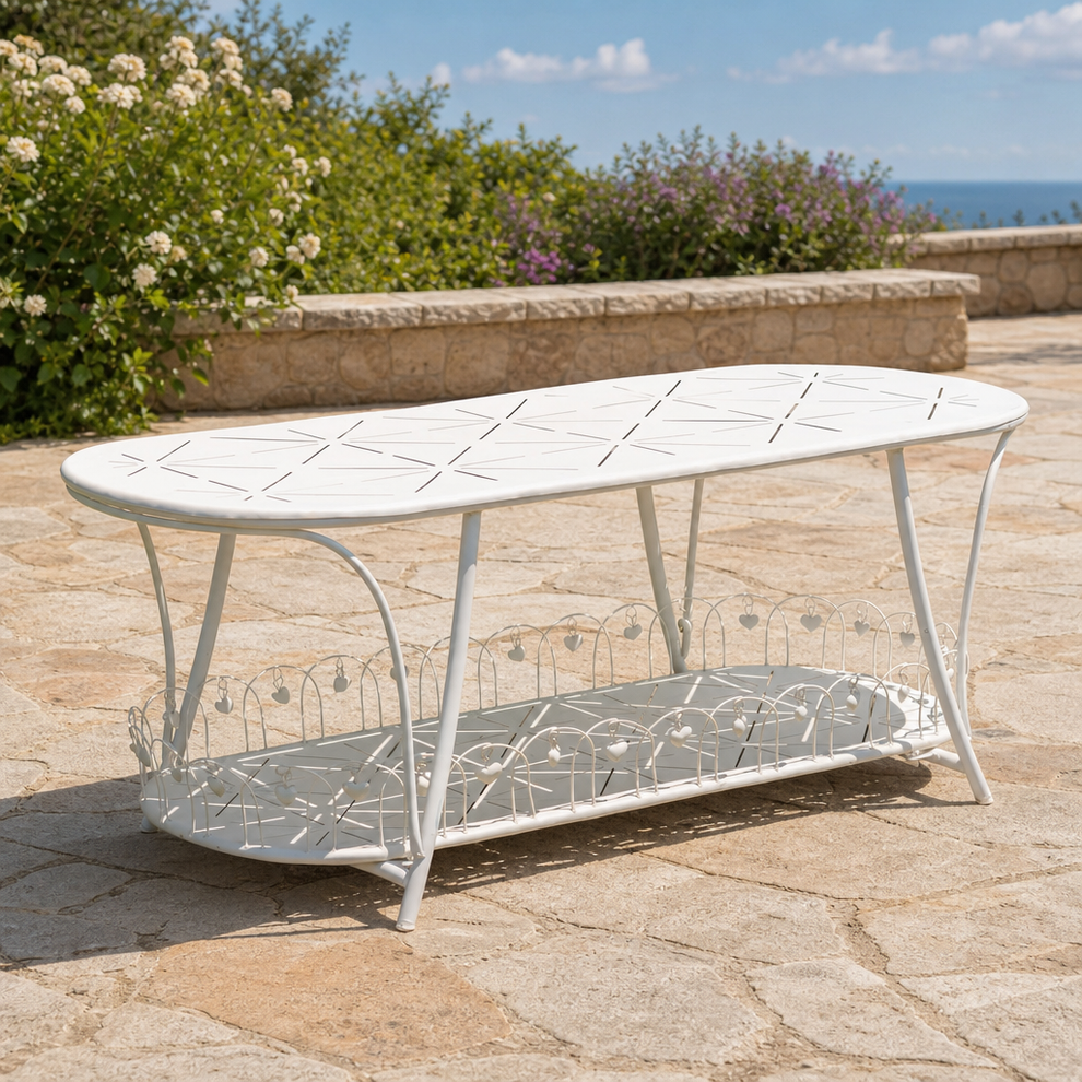 Oval Iron Garden Table with Lower Shelf, Antique White or Antique Blue centered in a warm neutral furnished room