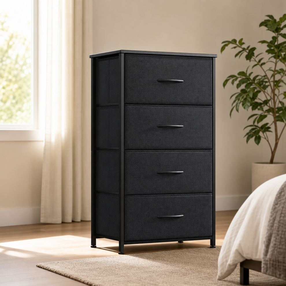 Black narrow fabric dresser with four drawers and wood top angled front view in a bright bedroom