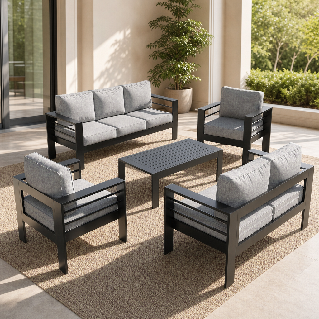 Dark grey aluminum outdoor patio conversation set with light grey cushions, angled top-down view.