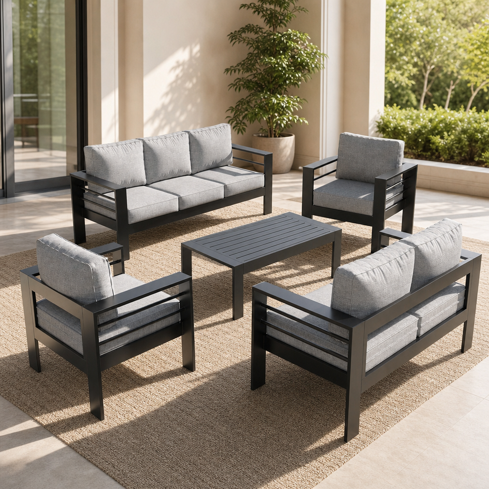Dark grey aluminum outdoor patio conversation set with light grey cushions, angled top-down view.