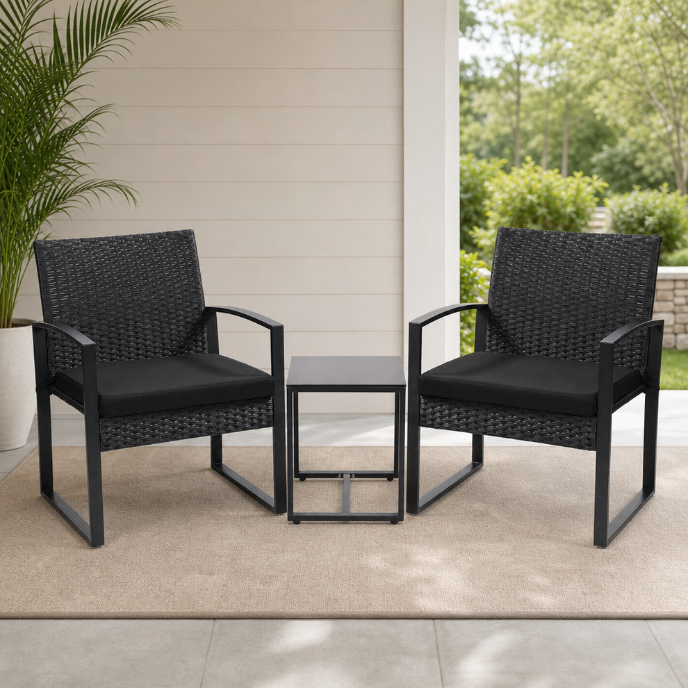 Black rattan two-seat bistro set with square tempered glass table on a porch rug, front view