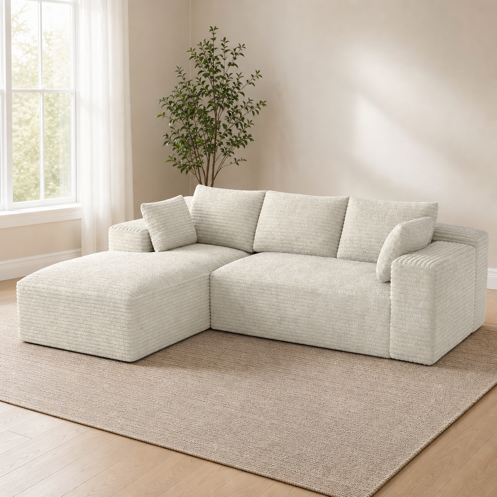 Two-Piece Boneless L-Shaped Modular Sectional with Extra-Deep Chaise centered in a warm neutral furnished room