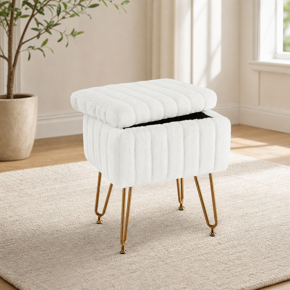 White faux-fur storage ottoman with removable top open and gold metal legs, angled front view in a bright room