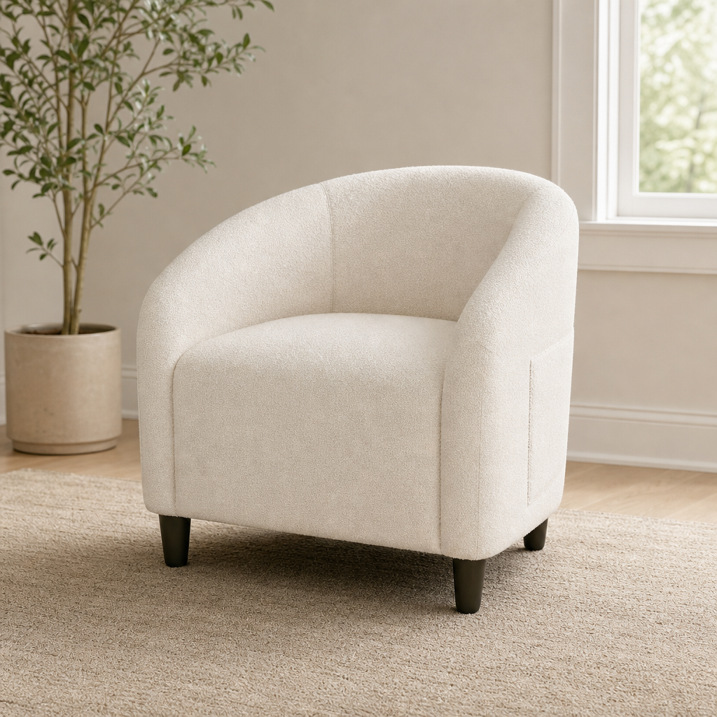 Beige boucle barrel accent chair angled front view on a rug near a window