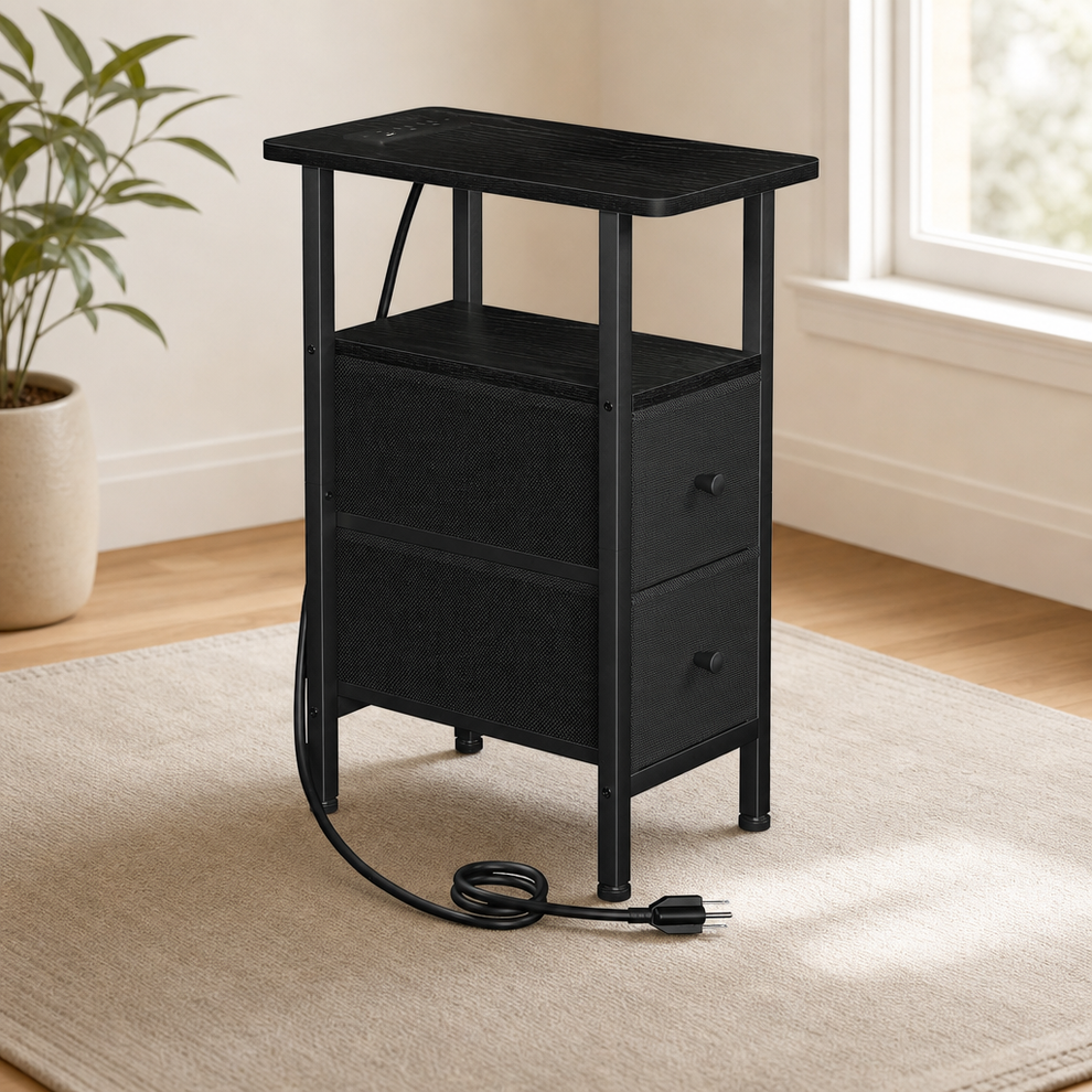 Black narrow side table with two fabric drawers angled front view showing coiled power cord on a rug