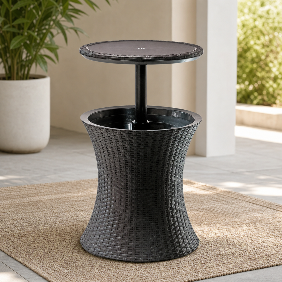 Dark grey wicker-style cooler table with raised round top on a woven rug in an outdoor patio setting