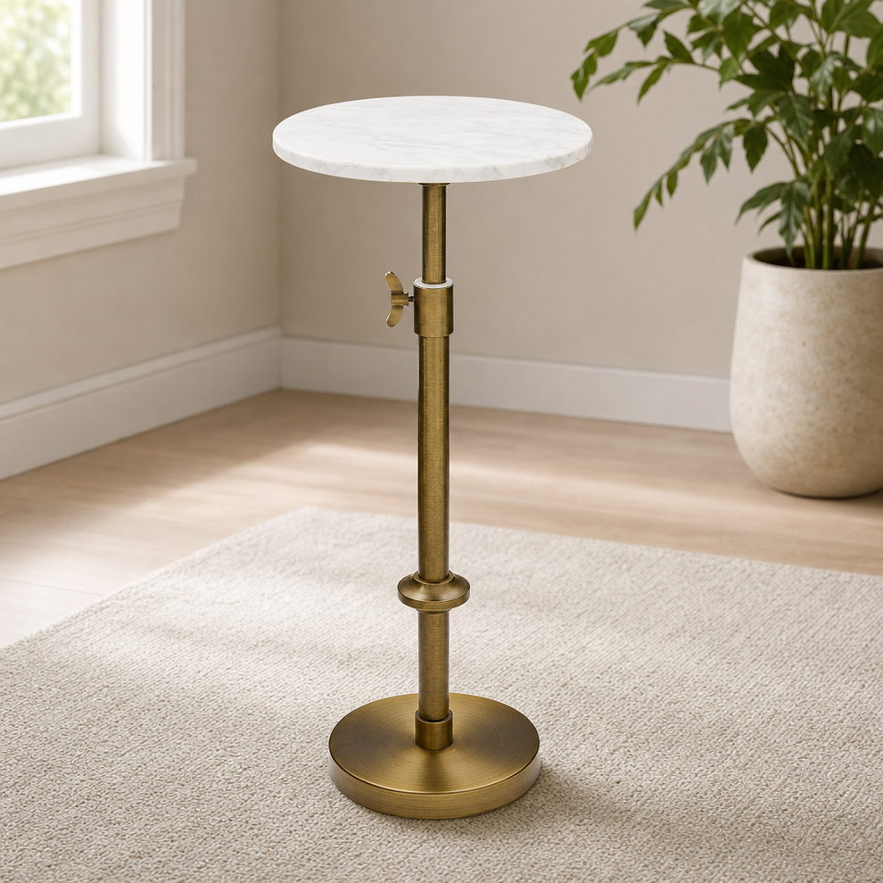 White marble round top with antique brass pedestal stand angled front view on a light rug near a window